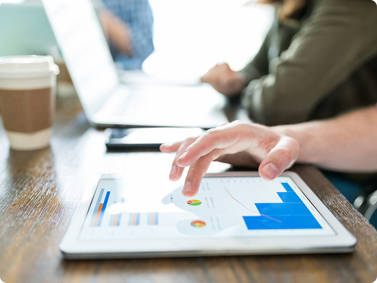 image of an ipad where a hand is editing some graphs